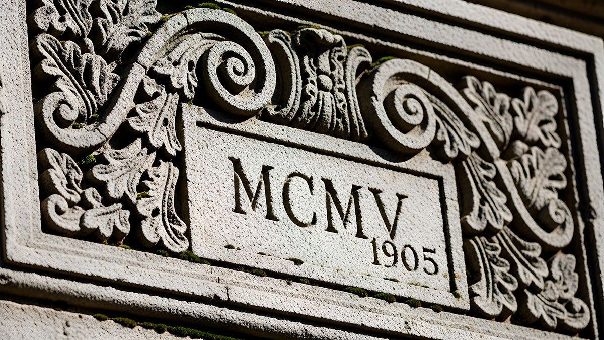 Roman numerals carved into a historic stone building.